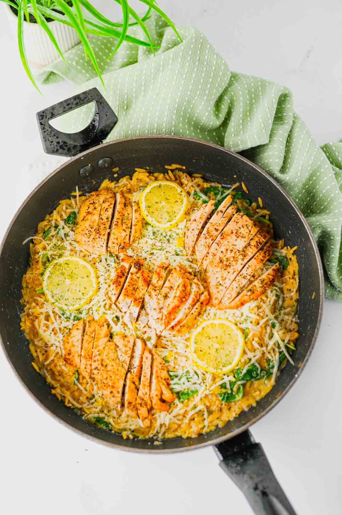 This Lemon Chicken Orzo is the perfect easy dinner when you’re craving creamy comfort food with a fresh, zesty twist! Tender seasoned chicken breast is served over creamy Parmesan orzo with baby spinach, garlic, Italian seasoning, heavy cream, fresh lemon juice and lemon zest. This easy Lemon Chicken Orzo Recipe comes together in one skillet in about 30 minutes, making it perfect for busy weeknights and simple family dinners. If you love One Pan Chicken Recipes, Creamy Chicken Orzo, Lemon Chicken Recipes and quick Orzo Dinner Recipes, this dish is a must-try. Serve this creamy Lemon Parmesan Chicken Orzo for an easy weeknight dinner, cozy family meal or simple date night at home. Save this easy chicken dinner recipe for the next time you need a flavorful meal everyone will love!