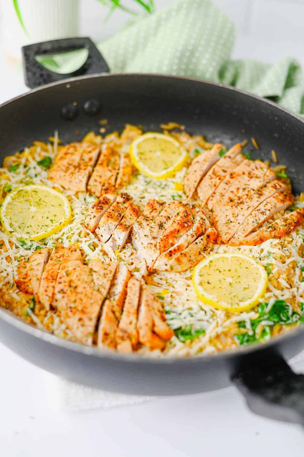 This Lemon Chicken Orzo is the perfect easy dinner when you’re craving creamy comfort food with a fresh, zesty twist! Tender seasoned chicken breast is served over creamy Parmesan orzo with baby spinach, garlic, Italian seasoning, heavy cream, fresh lemon juice and lemon zest. This easy Lemon Chicken Orzo Recipe comes together in one skillet in about 30 minutes, making it perfect for busy weeknights and simple family dinners. If you love One Pan Chicken Recipes, Creamy Chicken Orzo, Lemon Chicken Recipes and quick Orzo Dinner Recipes, this dish is a must-try. Serve this creamy Lemon Parmesan Chicken Orzo for an easy weeknight dinner, cozy family meal or simple date night at home. Save this easy chicken dinner recipe for the next time you need a flavorful meal everyone will love!