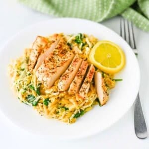 This Lemon Chicken Orzo is the perfect easy dinner when you’re craving creamy comfort food with a fresh, zesty twist! Tender seasoned chicken breast is served over creamy Parmesan orzo with baby spinach, garlic, Italian seasoning, heavy cream, fresh lemon juice and lemon zest. This easy Lemon Chicken Orzo Recipe comes together in one skillet in about 30 minutes, making it perfect for busy weeknights and simple family dinners. If you love One Pan Chicken Recipes, Creamy Chicken Orzo, Lemon Chicken Recipes and quick Orzo Dinner Recipes, this dish is a must-try. Serve this creamy Lemon Parmesan Chicken Orzo for an easy weeknight dinner, cozy family meal or simple date night at home. Save this easy chicken dinner recipe for the next time you need a flavorful meal everyone will love!