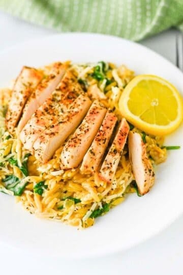 This Lemon Chicken Orzo is the perfect easy dinner when you’re craving creamy comfort food with a fresh, zesty twist! Tender seasoned chicken breast is served over creamy Parmesan orzo with baby spinach, garlic, Italian seasoning, heavy cream, fresh lemon juice and lemon zest. This easy Lemon Chicken Orzo Recipe comes together in one skillet in about 30 minutes, making it perfect for busy weeknights and simple family dinners. If you love One Pan Chicken Recipes, Creamy Chicken Orzo, Lemon Chicken Recipes and quick Orzo Dinner Recipes, this dish is a must-try. Serve this creamy Lemon Parmesan Chicken Orzo for an easy weeknight dinner, cozy family meal or simple date night at home. Save this easy chicken dinner recipe for the next time you need a flavorful meal everyone will love!