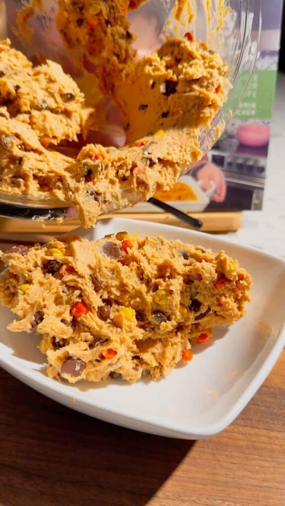 peanut butter dip mixture being scooped into a serving bowl