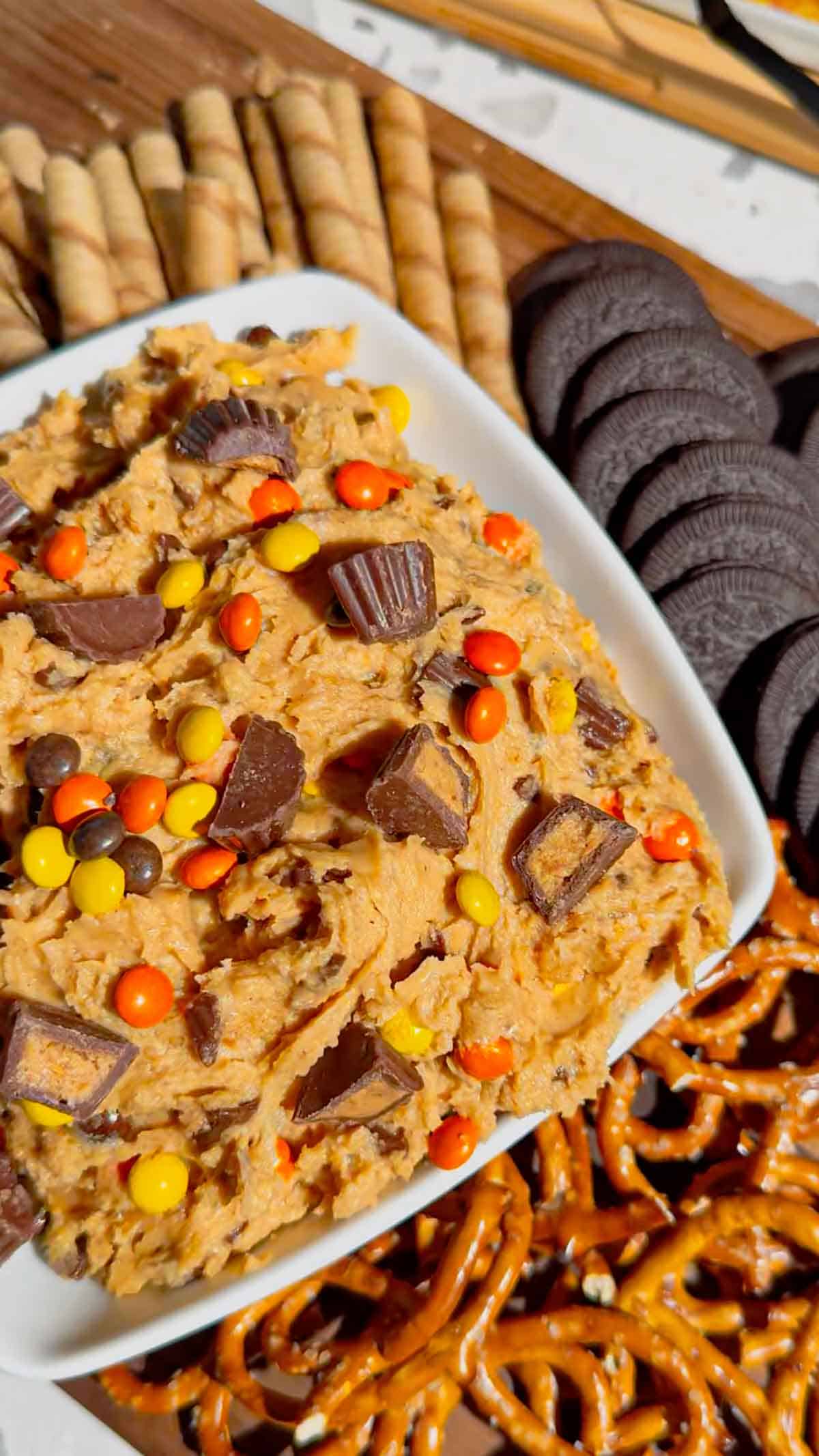 If you're looking for the ultimate Loaded Reese's Peanut Butter Dip, this easy no bake dessert is guaranteed to be a hit. Made with cream cheese, peanut butter, Cool Whip, brown sugar, Reese's Pieces, and chopped peanut butter cups, this creamy Peanut Butter Dip Recipe is rich, fluffy, and packed with chocolate and peanut butter flavor in every bite. It's the perfect Dessert Dip, Party Dip, No Bake Peanut Butter Dessert, and Reese's Dessert Recipe for game day, birthdays, potlucks, movie nights, holiday gatherings, or anytime you need a quick sweet treat. Serve it with graham crackers, pretzels, vanilla wafers, apple slices, or cookies for an irresistible snack everyone will keep coming back for. Save this easy peanut butter dessert recipe for your next party!
