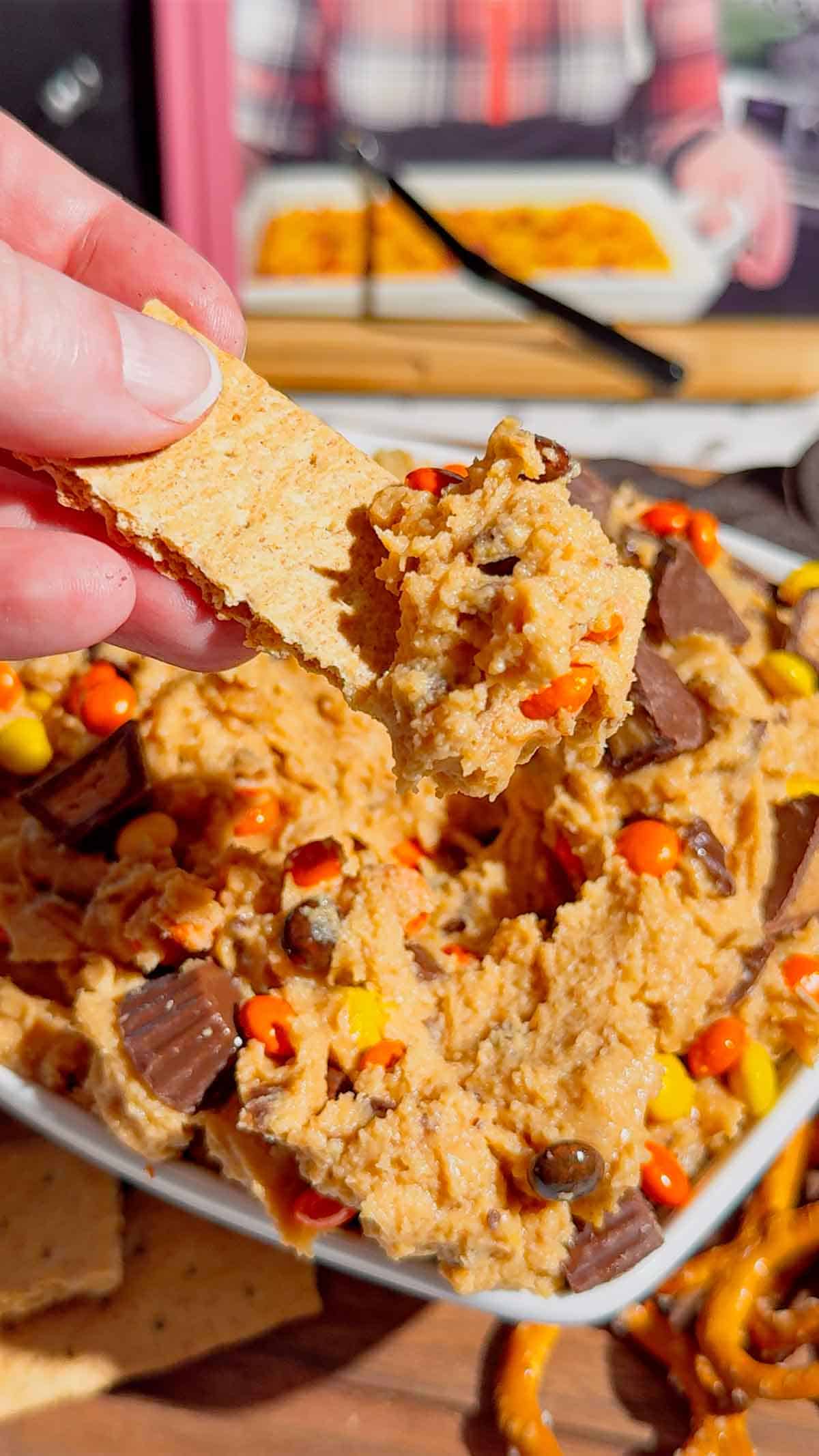 If you're looking for the ultimate Loaded Reese's Peanut Butter Dip, this easy no bake dessert is guaranteed to be a hit. Made with cream cheese, peanut butter, Cool Whip, brown sugar, Reese's Pieces, and chopped peanut butter cups, this creamy Peanut Butter Dip Recipe is rich, fluffy, and packed with chocolate and peanut butter flavor in every bite. It's the perfect Dessert Dip, Party Dip, No Bake Peanut Butter Dessert, and Reese's Dessert Recipe for game day, birthdays, potlucks, movie nights, holiday gatherings, or anytime you need a quick sweet treat. Serve it with graham crackers, pretzels, vanilla wafers, apple slices, or cookies for an irresistible snack everyone will keep coming back for. Save this easy peanut butter dessert recipe for your next party!