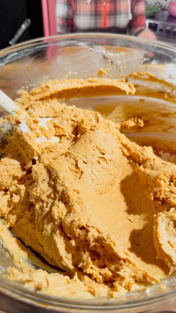peanut butter cream cheese mixture in a glass mixing bowl