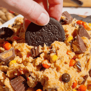 If you're looking for the ultimate Loaded Reese's Peanut Butter Dip, this easy no bake dessert is guaranteed to be a hit. Made with cream cheese, peanut butter, Cool Whip, brown sugar, Reese's Pieces, and chopped peanut butter cups, this creamy Peanut Butter Dip Recipe is rich, fluffy, and packed with chocolate and peanut butter flavor in every bite. It's the perfect Dessert Dip, Party Dip, No Bake Peanut Butter Dessert, and Reese's Dessert Recipe for game day, birthdays, potlucks, movie nights, holiday gatherings, or anytime you need a quick sweet treat. Serve it with graham crackers, pretzels, vanilla wafers, apple slices, or cookies for an irresistible snack everyone will keep coming back for. Save this easy peanut butter dessert recipe for your next party!