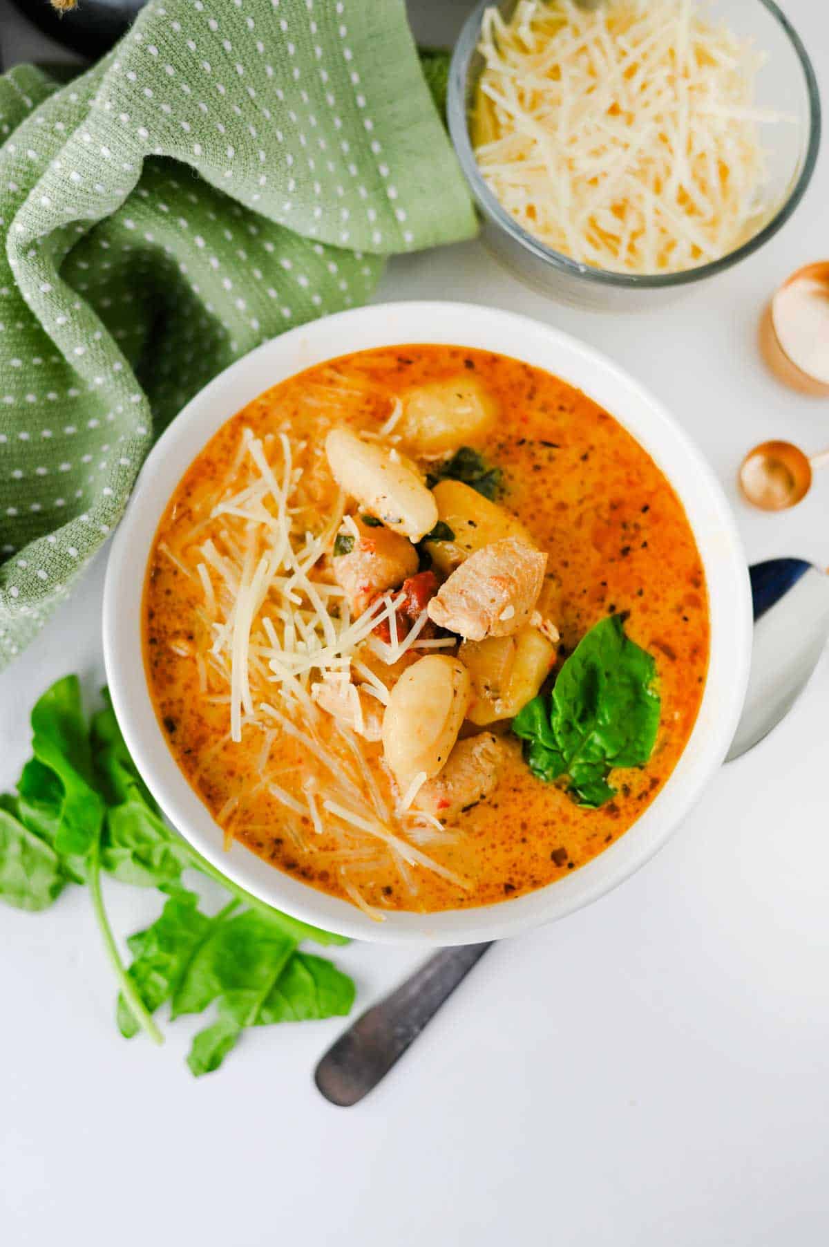 This Marry Me Chicken Soup is the cozy dinner for anyone craving a creamy, flavor-packed meal! Tender chicken, pillowy potato gnocchi, sun-dried tomatoes, spinach, pesto, Parmesan cheese, and heavy cream come together in a rich, savory broth that's impossible to resist. This easy Marry Me Chicken Soup Recipe is perfect for busy weeknights, chilly fall evenings, Sunday dinner, or whenever you need comforting Chicken Soup Recipes everyone will love. If you're searching for Creamy Chicken Soup, Gnocchi Soup Recipes, One Pot Dinner Ideas, Easy Chicken Dinner Recipes, hearty Fall Soup Recipes, or cozy Winter Soup Recipes, save this one! It's a satisfying creamy chicken gnocchi soup that's simple to make and loaded with big flavor. Save this easy soup recipe for your next comfort food dinner!