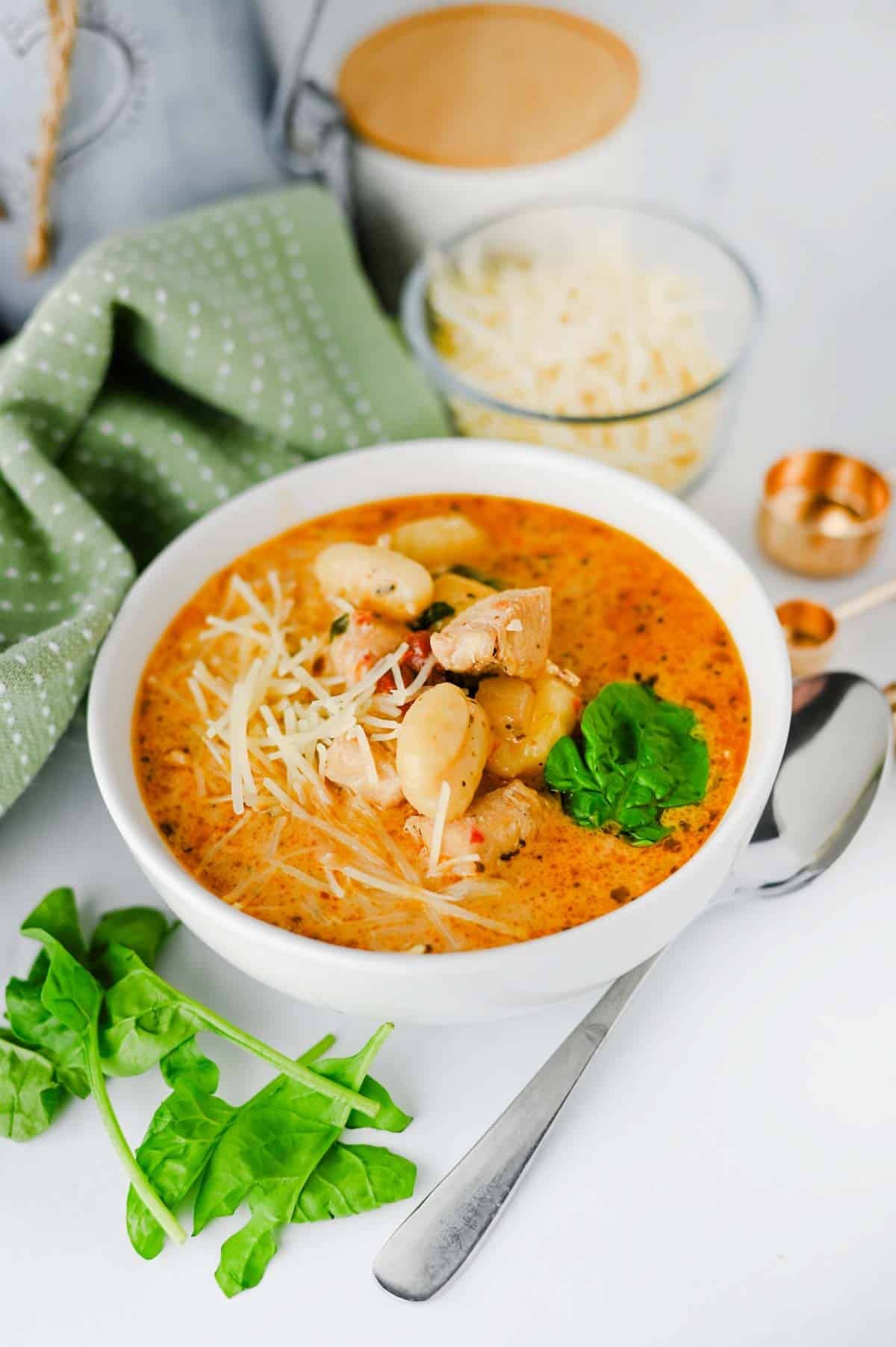 This Marry Me Chicken Soup is the cozy dinner for anyone craving a creamy, flavor-packed meal! Tender chicken, pillowy potato gnocchi, sun-dried tomatoes, spinach, pesto, Parmesan cheese, and heavy cream come together in a rich, savory broth that's impossible to resist. This easy Marry Me Chicken Soup Recipe is perfect for busy weeknights, chilly fall evenings, Sunday dinner, or whenever you need comforting Chicken Soup Recipes everyone will love. If you're searching for Creamy Chicken Soup, Gnocchi Soup Recipes, One Pot Dinner Ideas, Easy Chicken Dinner Recipes, hearty Fall Soup Recipes, or cozy Winter Soup Recipes, save this one! It's a satisfying creamy chicken gnocchi soup that's simple to make and loaded with big flavor. Save this easy soup recipe for your next comfort food dinner!