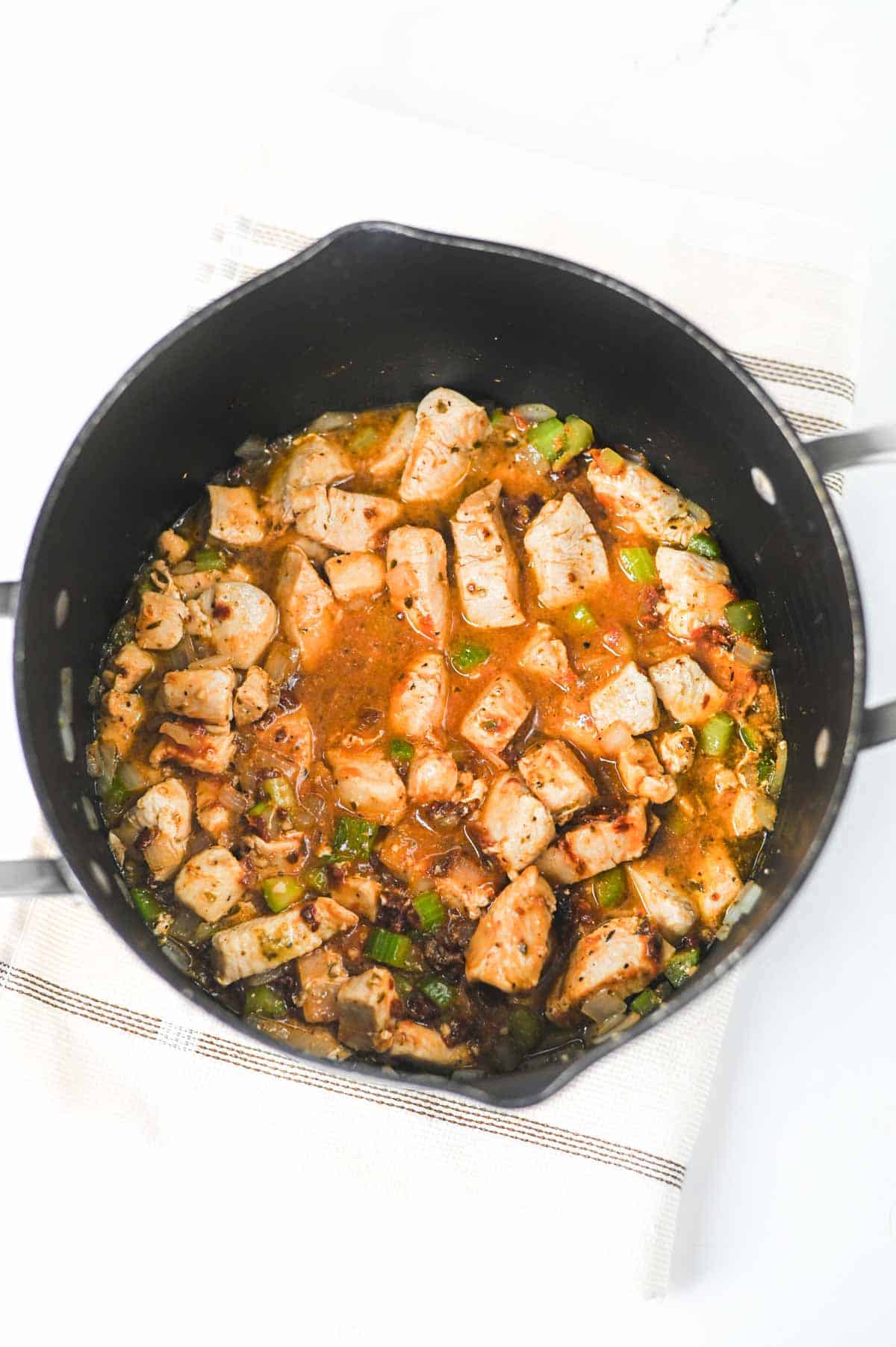 marry me chicken gnocchi soup ingredients in a pot