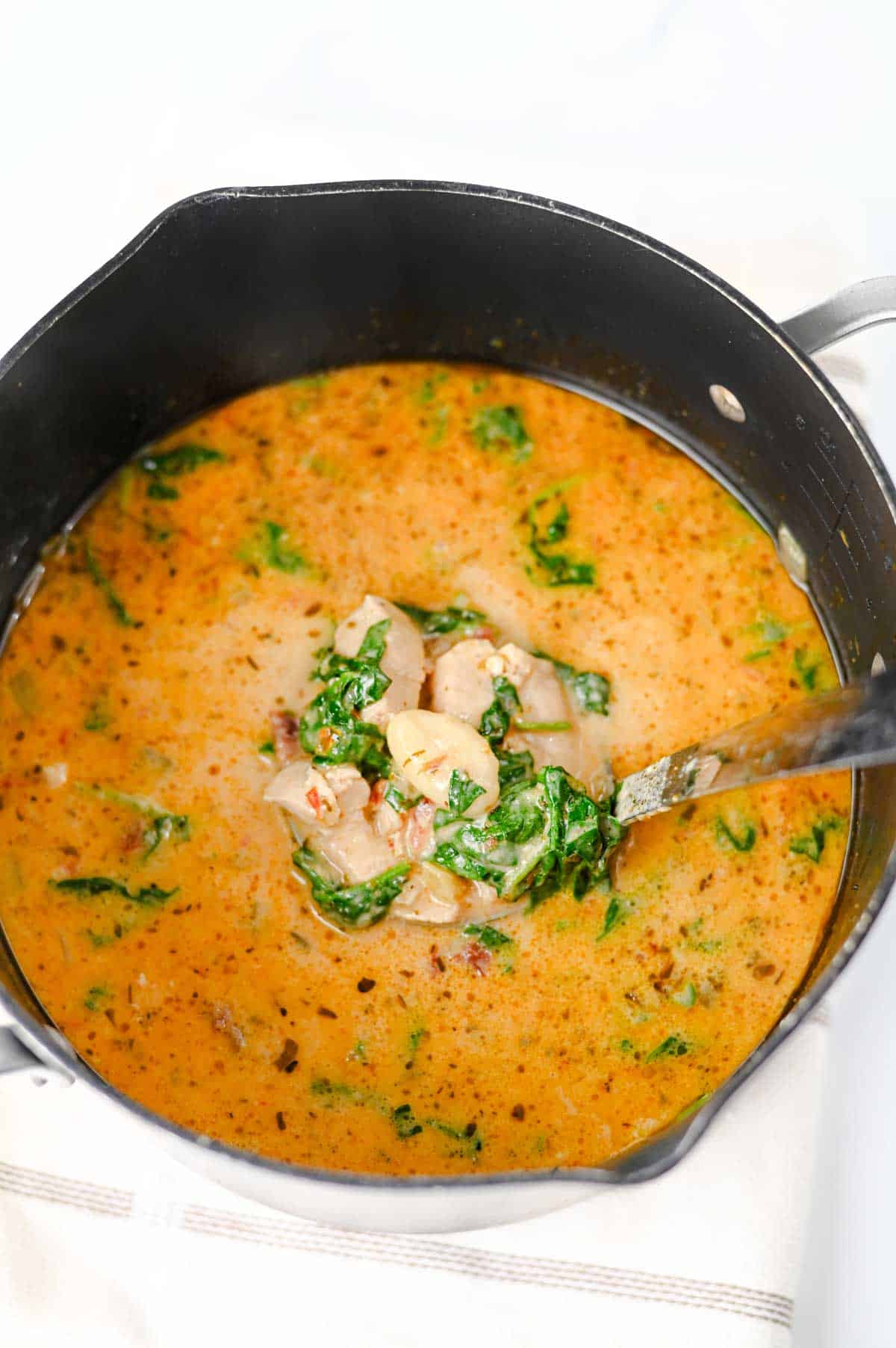 This Marry Me Chicken Soup is the cozy dinner for anyone craving a creamy, flavor-packed meal! Tender chicken, pillowy potato gnocchi, sun-dried tomatoes, spinach, pesto, Parmesan cheese, and heavy cream come together in a rich, savory broth that's impossible to resist. This easy Marry Me Chicken Soup Recipe is perfect for busy weeknights, chilly fall evenings, Sunday dinner, or whenever you need comforting Chicken Soup Recipes everyone will love. If you're searching for Creamy Chicken Soup, Gnocchi Soup Recipes, One Pot Dinner Ideas, Easy Chicken Dinner Recipes, hearty Fall Soup Recipes, or cozy Winter Soup Recipes, save this one! It's a satisfying creamy chicken gnocchi soup that's simple to make and loaded with big flavor. Save this easy soup recipe for your next comfort food dinner!