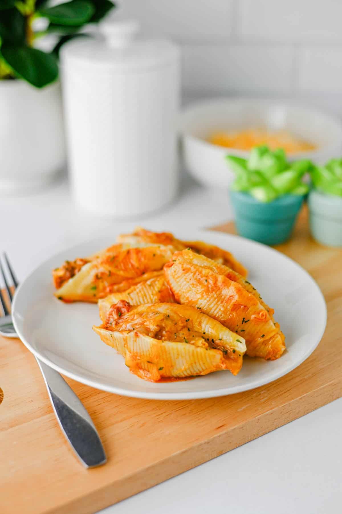 Mexican Stuffed Shells are an easy, cheesy dinner packed with bold Tex-Mex flavor! Jumbo pasta shells are filled with seasoned ground beef, taco seasoning, and cream cheese, then topped with enchilada sauce and shredded fiesta blend cheese before baking until hot and bubbly. This Mexican Stuffed Shells recipe is perfect when you need easy ground beef recipes for dinner, family friendly dinner ideas, quick weeknight meals, or a fun twist on classic stuffed shells. Add this cheesy ground beef casserole to your list of easy Mexican dinner recipes, taco inspired meals, pasta dinner ideas, and comfort food recipes. With simple ingredients and just 15 minutes of prep, these enchilada stuffed shells are great for busy nights, Taco Tuesday, or anytime you're craving cheesy Mexican pasta!