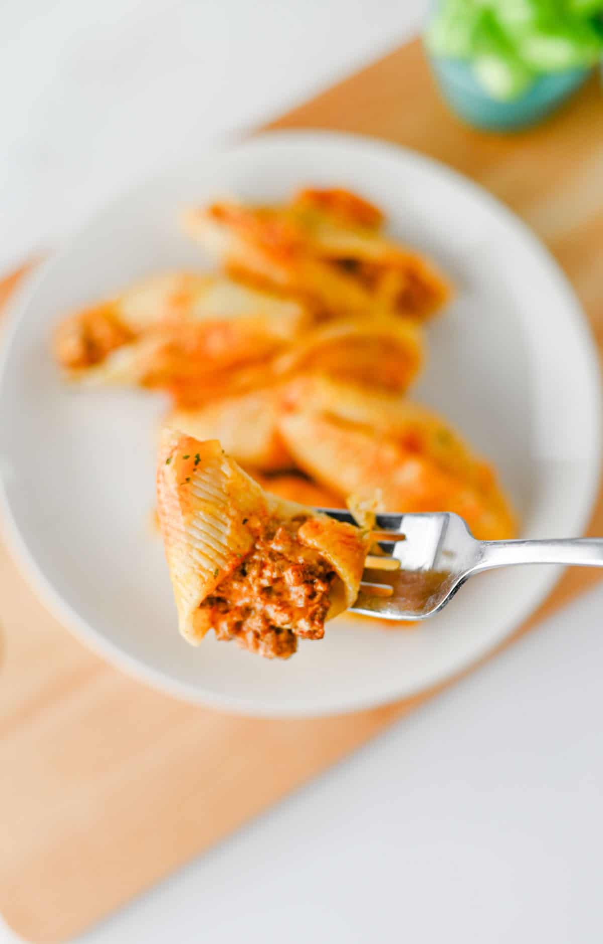 Mexican Stuffed Shells are an easy, cheesy dinner packed with bold Tex-Mex flavor! Jumbo pasta shells are filled with seasoned ground beef, taco seasoning, and cream cheese, then topped with enchilada sauce and shredded fiesta blend cheese before baking until hot and bubbly. This Mexican Stuffed Shells recipe is perfect when you need easy ground beef recipes for dinner, family friendly dinner ideas, quick weeknight meals, or a fun twist on classic stuffed shells. Add this cheesy ground beef casserole to your list of easy Mexican dinner recipes, taco inspired meals, pasta dinner ideas, and comfort food recipes. With simple ingredients and just 15 minutes of prep, these enchilada stuffed shells are great for busy nights, Taco Tuesday, or anytime you're craving cheesy Mexican pasta!