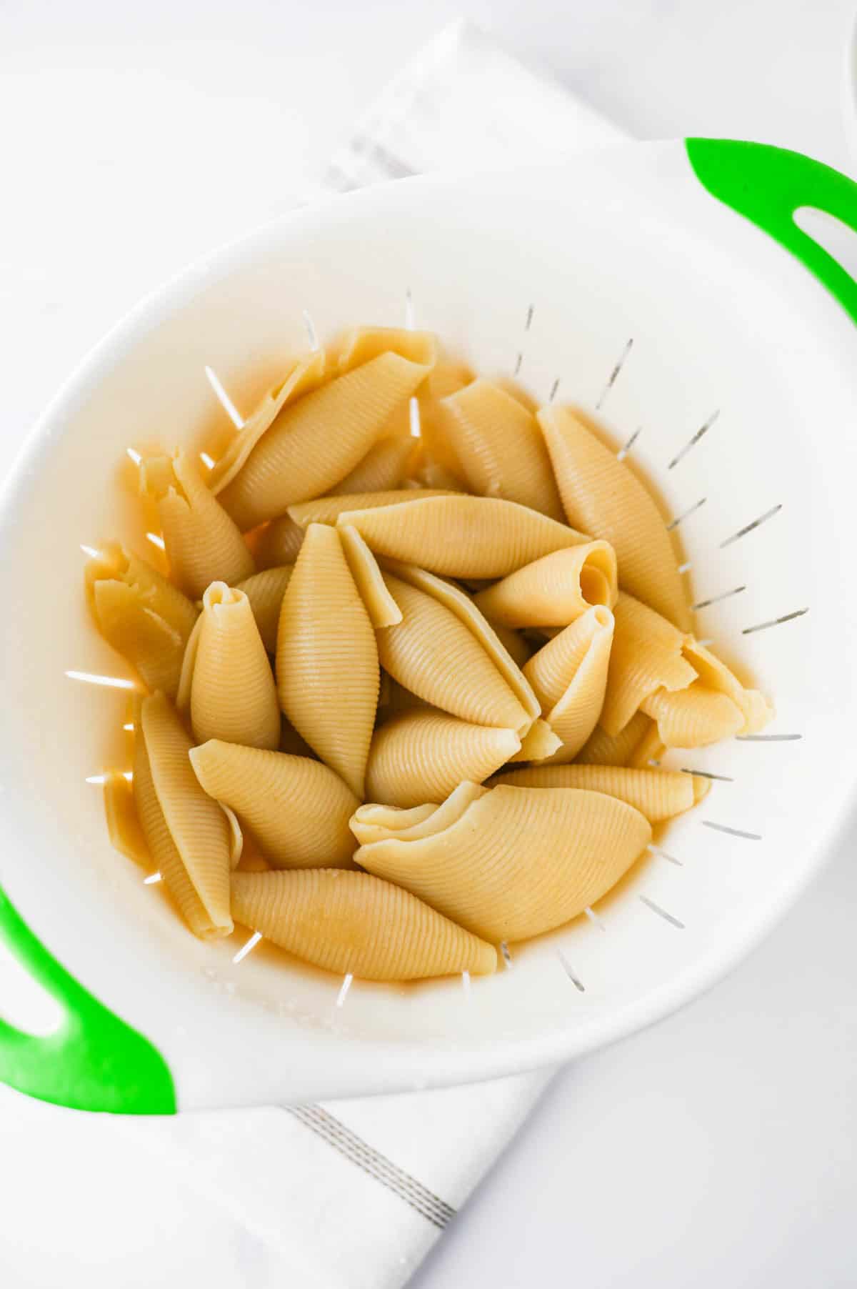 cooked pasta shells in a colander