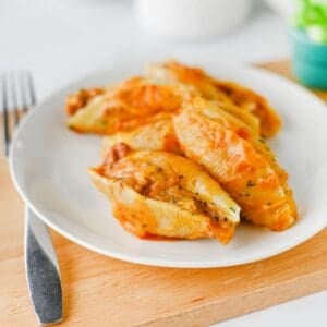 Mexican Stuffed Shells are an easy, cheesy dinner packed with bold Tex-Mex flavor! Jumbo pasta shells are filled with seasoned ground beef, taco seasoning, and cream cheese, then topped with enchilada sauce and shredded fiesta blend cheese before baking until hot and bubbly. This Mexican Stuffed Shells recipe is perfect when you need easy ground beef recipes for dinner, family friendly dinner ideas, quick weeknight meals, or a fun twist on classic stuffed shells. Add this cheesy ground beef casserole to your list of easy Mexican dinner recipes, taco inspired meals, pasta dinner ideas, and comfort food recipes. With simple ingredients and just 15 minutes of prep, these enchilada stuffed shells are great for busy nights, Taco Tuesday, or anytime you're craving cheesy Mexican pasta!