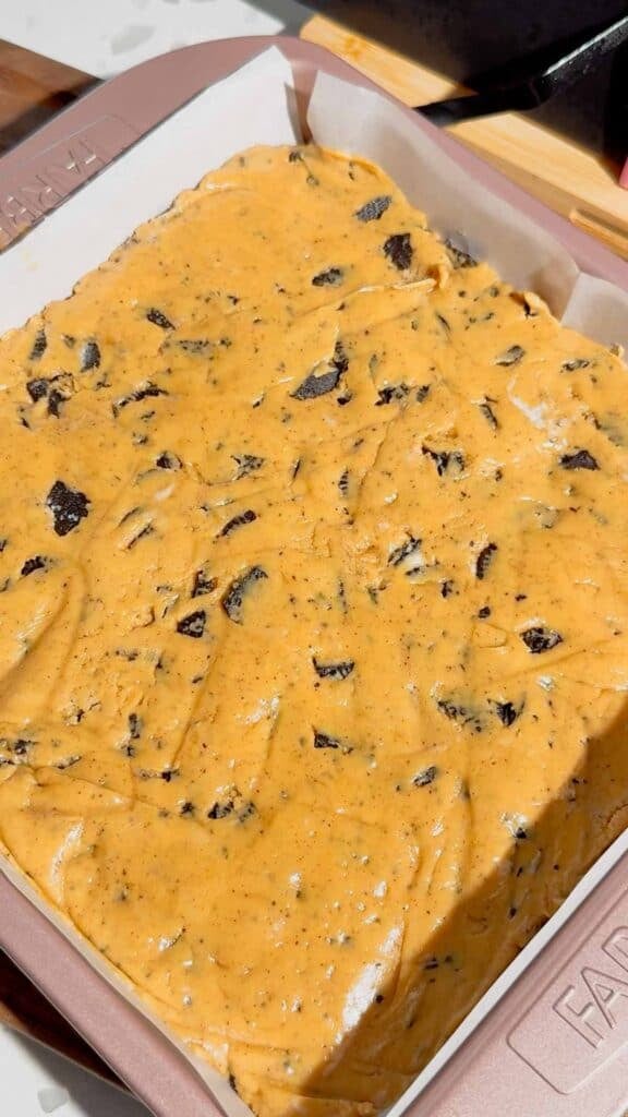 This Oreo Peanut Butter Fudge is the ultimate easy no bake dessert for peanut butter and chocolate lovers! Loaded with mini Reese’s Peanut Butter Cups, creamy peanut butter, peanut butter baking chips, vanilla frosting, and crunchy mini Oreos, this rich homemade fudge is packed with irresistible flavor. If you’re looking for Easy Fudge Recipes, Oreo Desserts, Peanut Butter Desserts, Reese’s Desserts, or No Bake Dessert Recipes, this simple treat is a must-try. Perfect for Christmas Candy, Holiday Desserts, Cookie Exchange Recipes, Party Desserts, Potluck Desserts, and homemade edible gifts, this Microwave Fudge Recipe takes just 15 minutes of prep. Save this Oreo Fudge Recipe when you need an easy dessert that combines cookies and cream with creamy peanut butter and Reese’s candy in every bite!