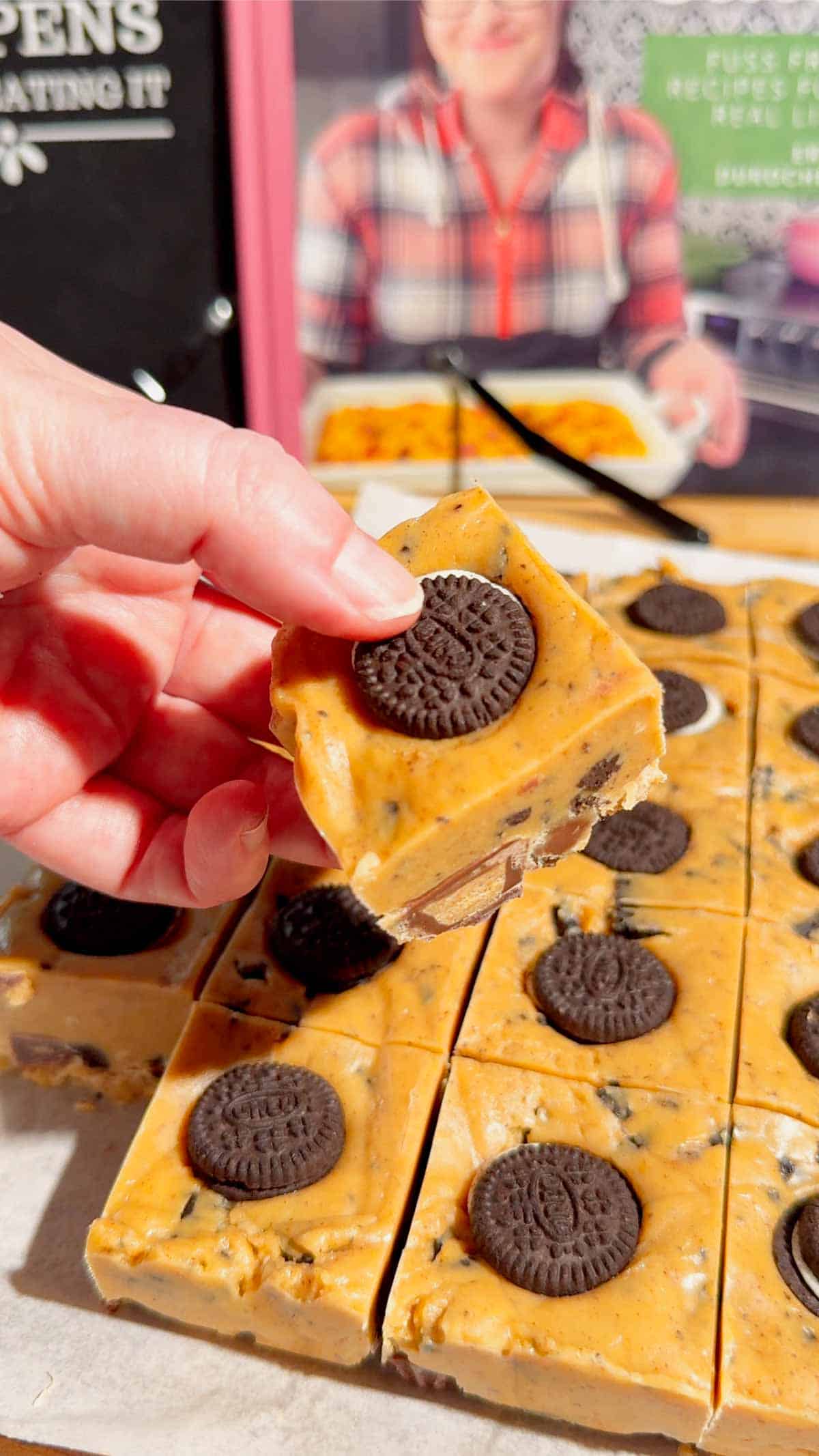 This Oreo Peanut Butter Fudge is the ultimate easy no bake dessert for peanut butter and chocolate lovers! Loaded with mini Reese’s Peanut Butter Cups, creamy peanut butter, peanut butter baking chips, vanilla frosting, and crunchy mini Oreos, this rich homemade fudge is packed with irresistible flavor. If you’re looking for Easy Fudge Recipes, Oreo Desserts, Peanut Butter Desserts, Reese’s Desserts, or No Bake Dessert Recipes, this simple treat is a must-try. Perfect for Christmas Candy, Holiday Desserts, Cookie Exchange Recipes, Party Desserts, Potluck Desserts, and homemade edible gifts, this Microwave Fudge Recipe takes just 15 minutes of prep. Save this Oreo Fudge Recipe when you need an easy dessert that combines cookies and cream with creamy peanut butter and Reese’s candy in every bite!