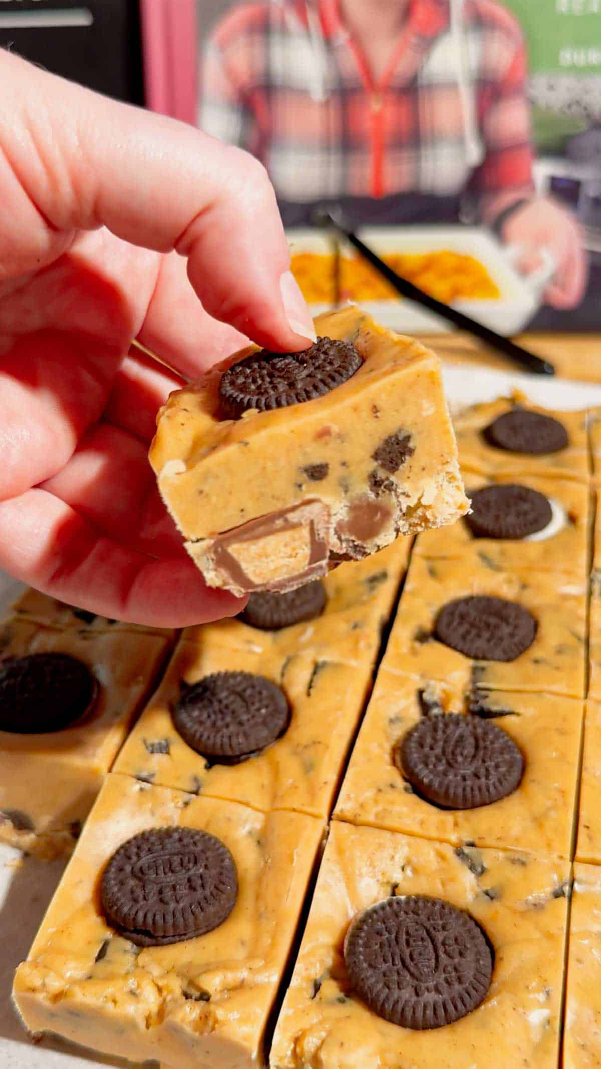 This Oreo Peanut Butter Fudge is the ultimate easy no bake dessert for peanut butter and chocolate lovers! Loaded with mini Reese’s Peanut Butter Cups, creamy peanut butter, peanut butter baking chips, vanilla frosting, and crunchy mini Oreos, this rich homemade fudge is packed with irresistible flavor. If you’re looking for Easy Fudge Recipes, Oreo Desserts, Peanut Butter Desserts, Reese’s Desserts, or No Bake Dessert Recipes, this simple treat is a must-try. Perfect for Christmas Candy, Holiday Desserts, Cookie Exchange Recipes, Party Desserts, Potluck Desserts, and homemade edible gifts, this Microwave Fudge Recipe takes just 15 minutes of prep. Save this Oreo Fudge Recipe when you need an easy dessert that combines cookies and cream with creamy peanut butter and Reese’s candy in every bite!