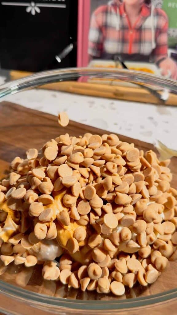 peanut butter baking chips added to mixing bowl with peanut butter and cream cheese
