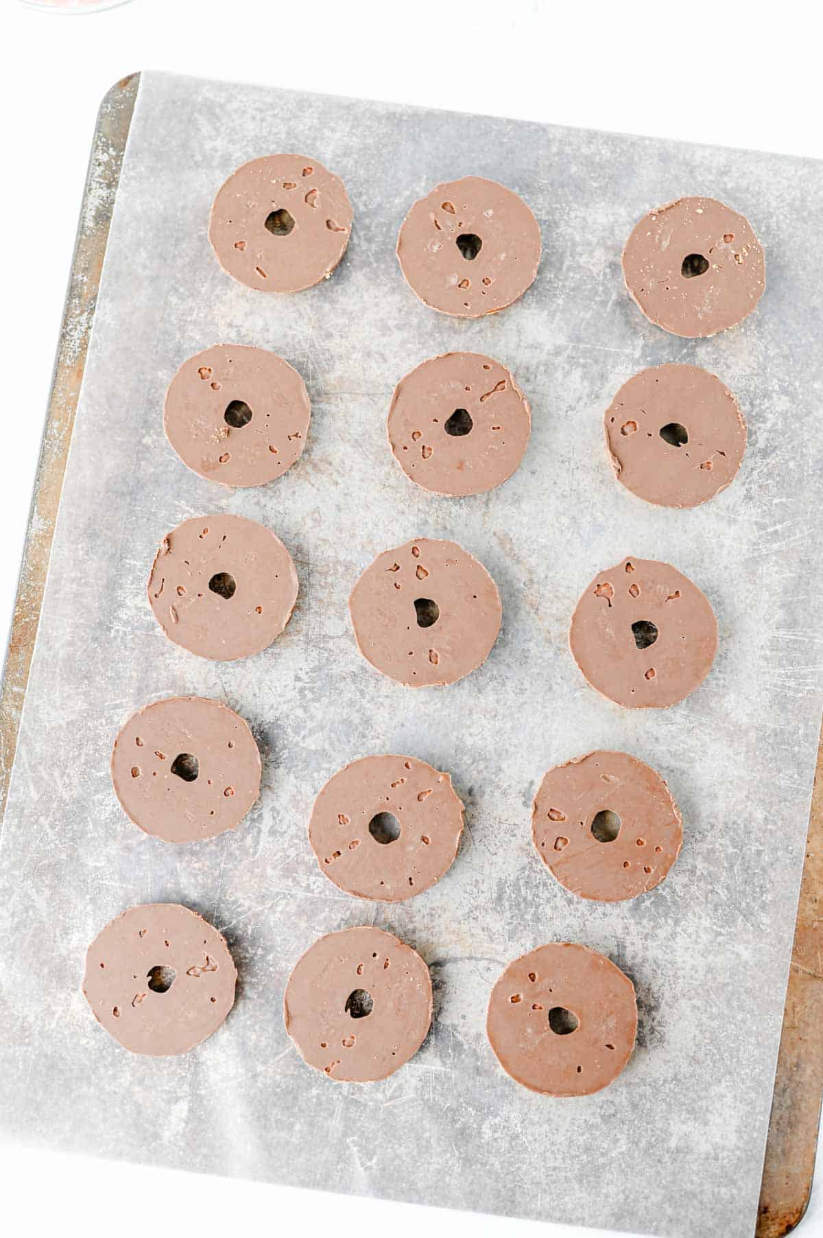 upside down fudge striped cookies on a parchment lined baking sheet