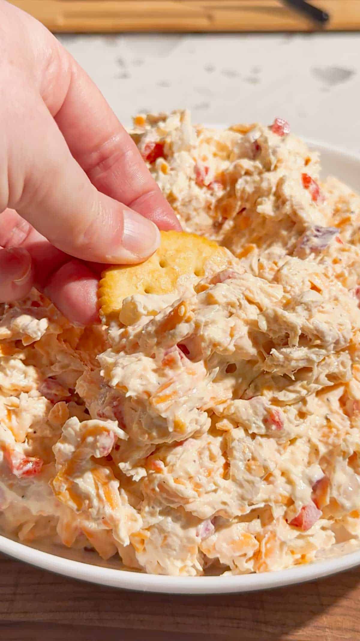 This Pimento Cheese Chicken Salad is a creamy, cheesy twist on classic chicken salad that's perfect for quick lunches, easy dinners, meal prep, parties and potlucks. Made with shredded chicken, cream cheese, mayonnaise, cheddar cheese, diced pimentos, red onion and simple seasonings, this easy chicken salad recipe comes together in just 15 minutes with no cooking required. If you love Southern pimento cheese, this Pimento Cheese Chicken Salad Recipe delivers all that rich, tangy flavor in a hearty chicken salad. Serve it on croissants, sandwich bread, crackers, lettuce wraps or tortillas for an easy lunch idea. This creamy chicken salad with cream cheese is perfect for leftover chicken or rotisserie chicken. Save this easy Pimento Cheese Chicken Salad for busy weekdays and summer lunches!