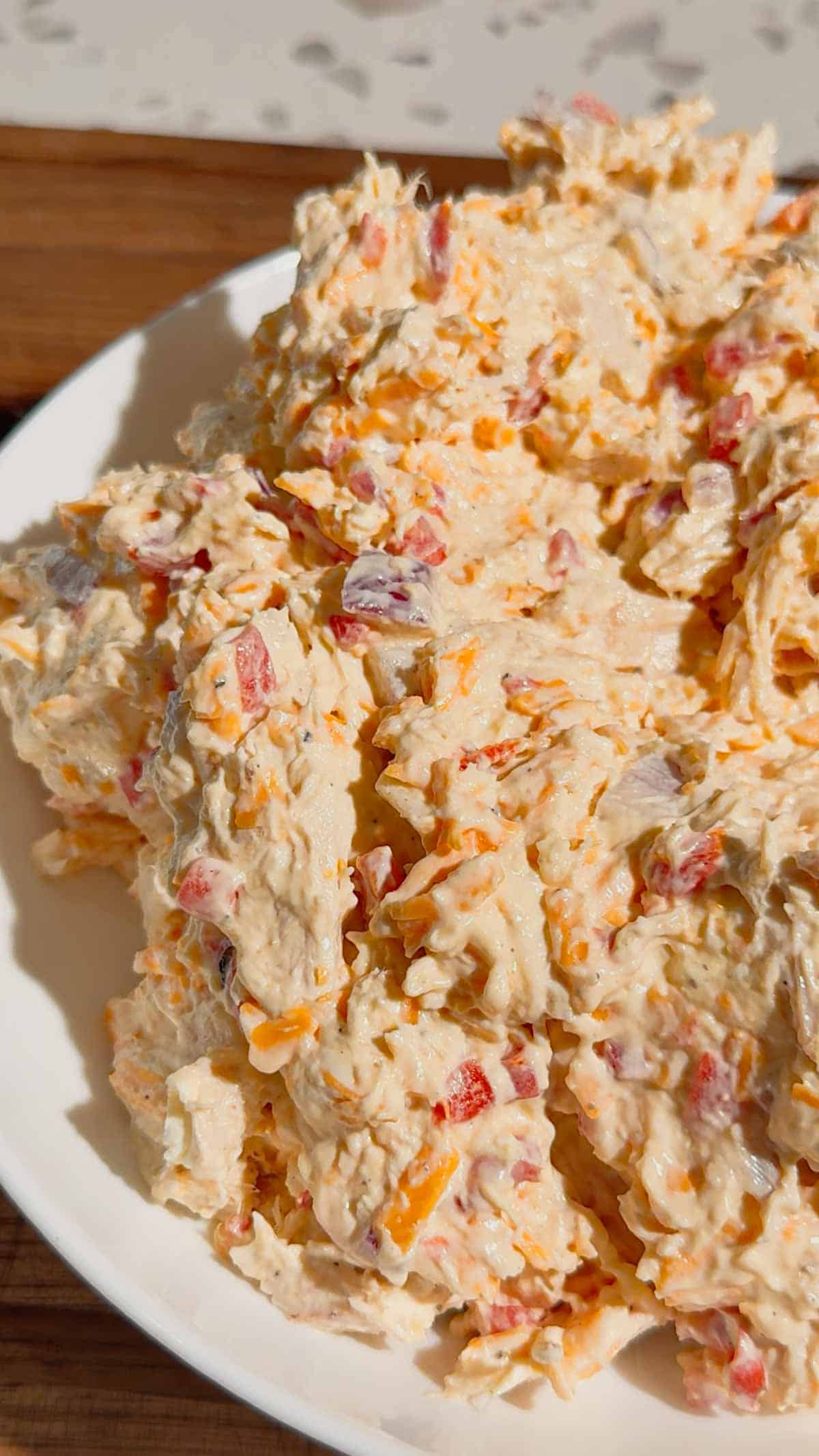 This Pimento Cheese Chicken Salad is a creamy, cheesy twist on classic chicken salad that's perfect for quick lunches, easy dinners, meal prep, parties and potlucks. Made with shredded chicken, cream cheese, mayonnaise, cheddar cheese, diced pimentos, red onion and simple seasonings, this easy chicken salad recipe comes together in just 15 minutes with no cooking required. If you love Southern pimento cheese, this Pimento Cheese Chicken Salad Recipe delivers all that rich, tangy flavor in a hearty chicken salad. Serve it on croissants, sandwich bread, crackers, lettuce wraps or tortillas for an easy lunch idea. This creamy chicken salad with cream cheese is perfect for leftover chicken or rotisserie chicken. Save this easy Pimento Cheese Chicken Salad for busy weekdays and summer lunches!