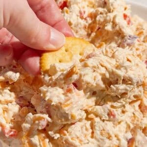 This Pimento Cheese Chicken Salad is a creamy, cheesy twist on classic chicken salad that's perfect for quick lunches, easy dinners, meal prep, parties and potlucks. Made with shredded chicken, cream cheese, mayonnaise, cheddar cheese, diced pimentos, red onion and simple seasonings, this easy chicken salad recipe comes together in just 15 minutes with no cooking required. If you love Southern pimento cheese, this Pimento Cheese Chicken Salad Recipe delivers all that rich, tangy flavor in a hearty chicken salad. Serve it on croissants, sandwich bread, crackers, lettuce wraps or tortillas for an easy lunch idea. This creamy chicken salad with cream cheese is perfect for leftover chicken or rotisserie chicken. Save this easy Pimento Cheese Chicken Salad for busy weekdays and summer lunches!