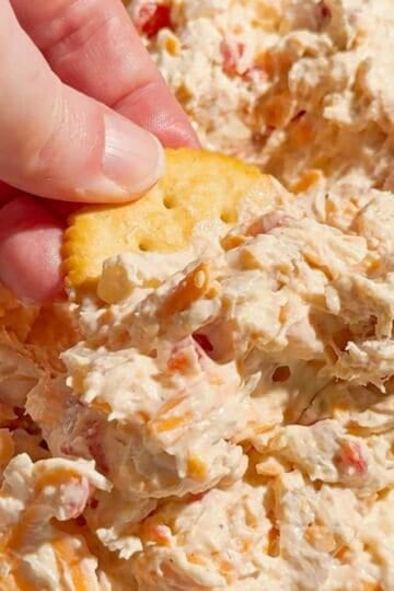 This Pimento Cheese Chicken Salad is a creamy, cheesy twist on classic chicken salad that's perfect for quick lunches, easy dinners, meal prep, parties and potlucks. Made with shredded chicken, cream cheese, mayonnaise, cheddar cheese, diced pimentos, red onion and simple seasonings, this easy chicken salad recipe comes together in just 15 minutes with no cooking required. If you love Southern pimento cheese, this Pimento Cheese Chicken Salad Recipe delivers all that rich, tangy flavor in a hearty chicken salad. Serve it on croissants, sandwich bread, crackers, lettuce wraps or tortillas for an easy lunch idea. This creamy chicken salad with cream cheese is perfect for leftover chicken or rotisserie chicken. Save this easy Pimento Cheese Chicken Salad for busy weekdays and summer lunches!