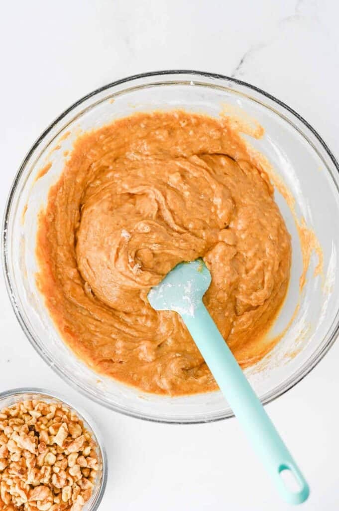 pumpkin banana bread batter in a glass mixing bowl