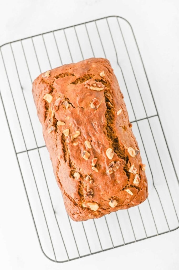 This Pumpkin Banana Bread is the ultimate cozy fall baking recipe, combining moist banana bread with pumpkin puree and warm pumpkin pie spice in one easy homemade loaf. If you love Pumpkin Bread Recipes, Banana Bread Recipes, Pumpkin Banana Bread Recipes, and Easy Fall Baking Recipes, this simple quick bread is a must-try. Ripe bananas and pumpkin puree keep every slice incredibly soft and moist, while brown sugar adds rich sweetness and chopped walnuts bring a delicious crunch. Serve this Easy Pumpkin Banana Bread for breakfast, brunch, dessert, or an afternoon snack with coffee. It's a delicious way to use Overripe Bananas and Canned Pumpkin and belongs on every list of Fall Bread Recipes, Pumpkin Recipes, Fall Desserts, Autumn Baking Ideas, and Cozy Fall Recipes.