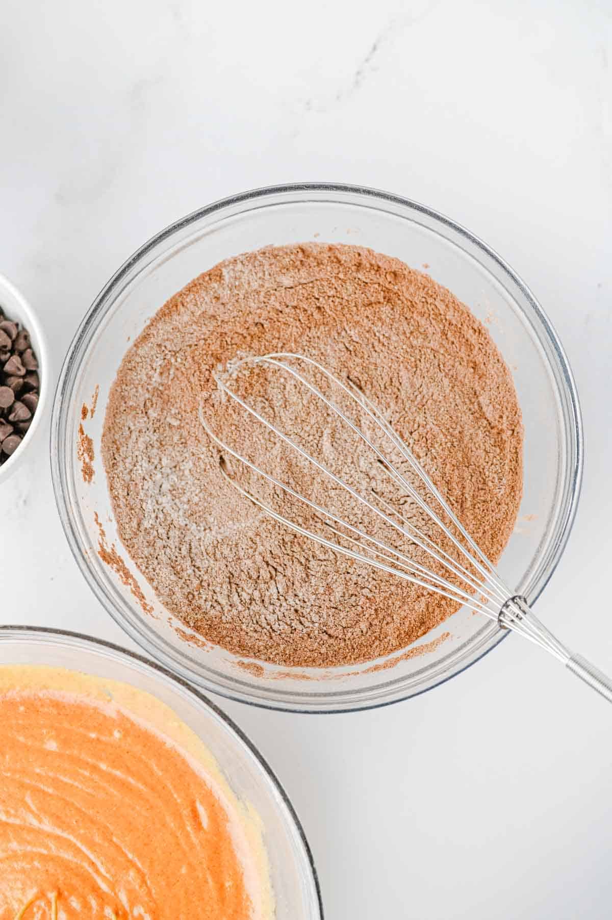pumpkin chocolate muffins dry ingredients whisked together in a glass mixing bowl