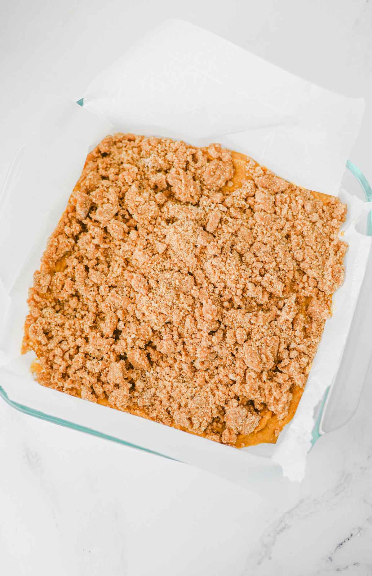 This Pumpkin Coffee Cake is the ultimate cozy fall baking recipe, made with pumpkin puree, warm cinnamon, nutmeg, ginger, brown sugar, and a touch of maple syrup. This easy Pumpkin Coffee Cake Recipe is soft, moist, and topped with a buttery cinnamon brown sugar crumb topping for the perfect sweet crunch. Add the simple powdered sugar icing for an extra decadent finish! If you're looking for Easy Pumpkin Desserts, Pumpkin Breakfast Recipes, Fall Baking Ideas, Pumpkin Spice Recipes, or delicious Fall Brunch Recipes, this homemade coffee cake is a must-try. It's perfect for Thanksgiving breakfast, holiday brunch, weekend baking, or enjoying with a hot cup of coffee. Save this Easy Pumpkin Coffee Cake for pumpkin season when you need a simple Pumpkin Dessert that's packed with cozy fall flavor!