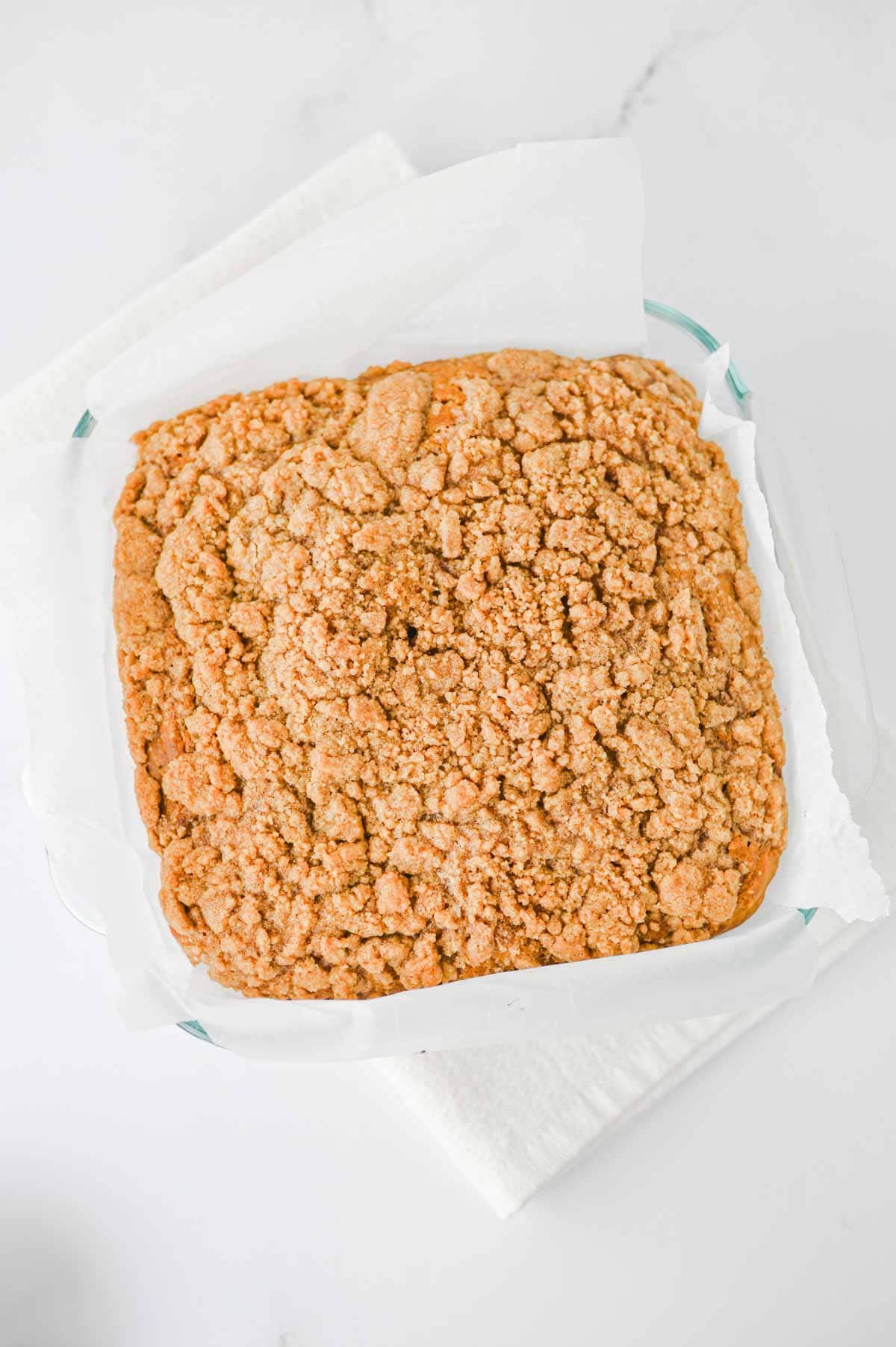 This Pumpkin Coffee Cake is the ultimate cozy fall baking recipe, made with pumpkin puree, warm cinnamon, nutmeg, ginger, brown sugar, and a touch of maple syrup. This easy Pumpkin Coffee Cake Recipe is soft, moist, and topped with a buttery cinnamon brown sugar crumb topping for the perfect sweet crunch. Add the simple powdered sugar icing for an extra decadent finish! If you're looking for Easy Pumpkin Desserts, Pumpkin Breakfast Recipes, Fall Baking Ideas, Pumpkin Spice Recipes, or delicious Fall Brunch Recipes, this homemade coffee cake is a must-try. It's perfect for Thanksgiving breakfast, holiday brunch, weekend baking, or enjoying with a hot cup of coffee. Save this Easy Pumpkin Coffee Cake for pumpkin season when you need a simple Pumpkin Dessert that's packed with cozy fall flavor!
