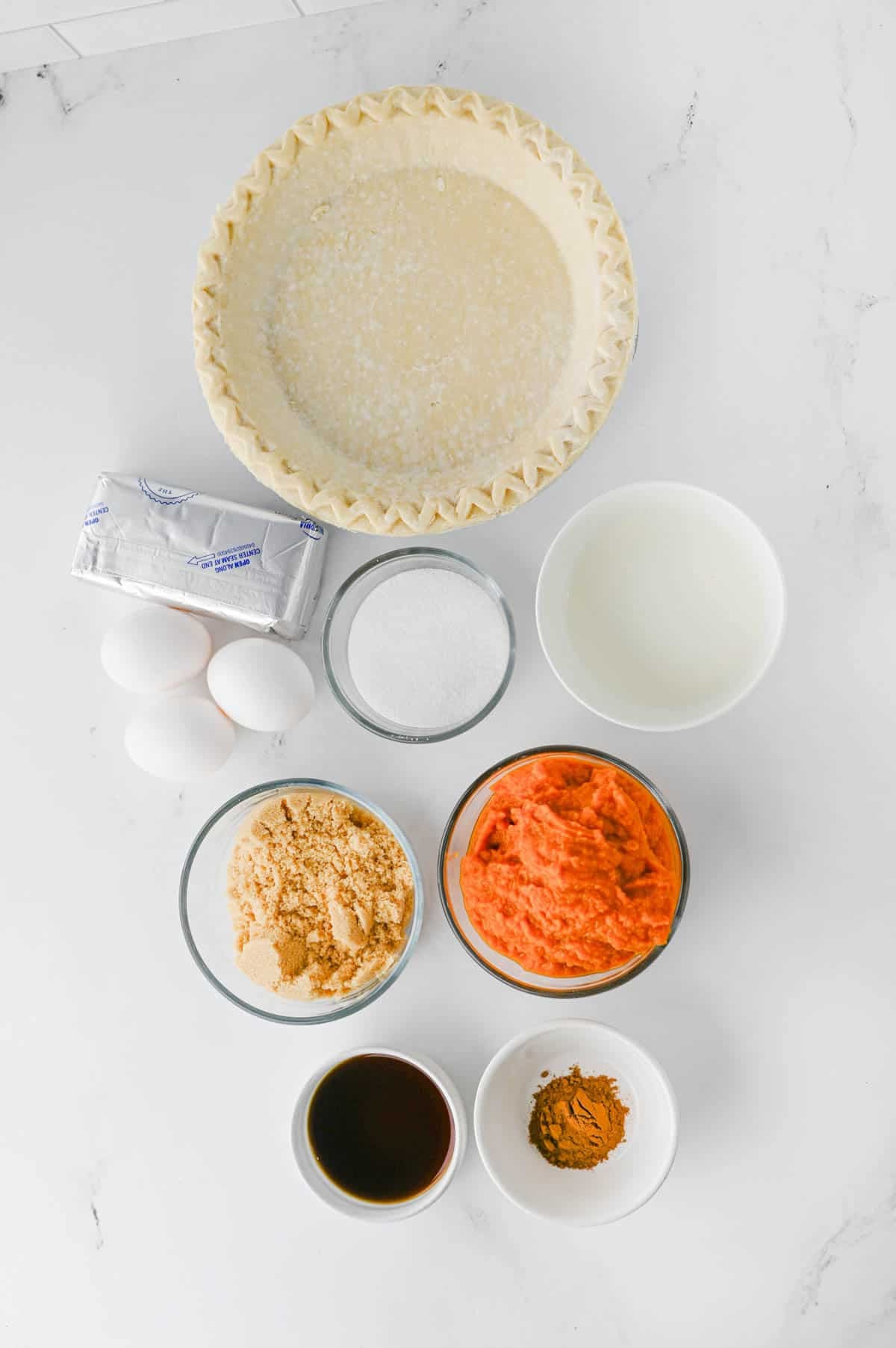 pumpkin pie cheesecake ingredients on the kitchen counter
