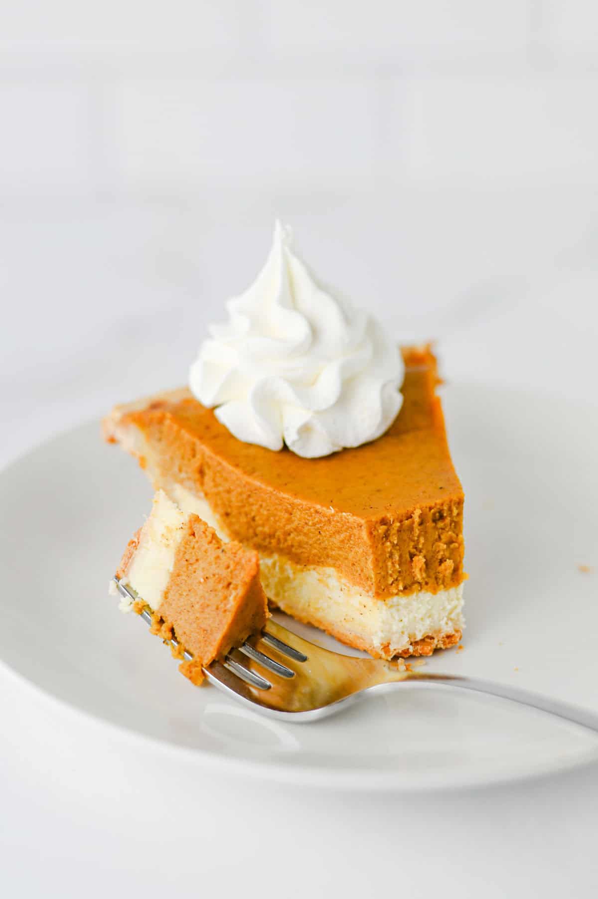 Pumpkin Pie Cheesecake is the perfect fall dessert when you can’t decide between classic pumpkin pie and creamy cheesecake! This easy Pumpkin Pie Cheesecake Recipe starts with a premade flaky pie crust and layers a sweet vanilla cream cheese filling with a rich pumpkin pie filling made with pumpkin puree, brown sugar, pumpkin pie spice, eggs, and heavy cream. It’s a delicious Thanksgiving dessert, holiday pie recipe, and fall baking idea for family dinners, potlucks, Friendsgiving, or Christmas. If you love easy pumpkin desserts, pumpkin cheesecake recipes, homemade pumpkin pie, and creamy cheesecake, this layered dessert is a must-try. Save this easy pumpkin cheesecake pie for your fall dessert recipes, Thanksgiving pie ideas, holiday baking, and pumpkin recipes to make all season long!