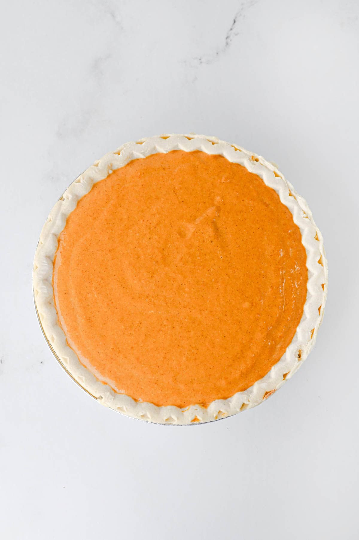 pumpkin pie filling in a pie crust