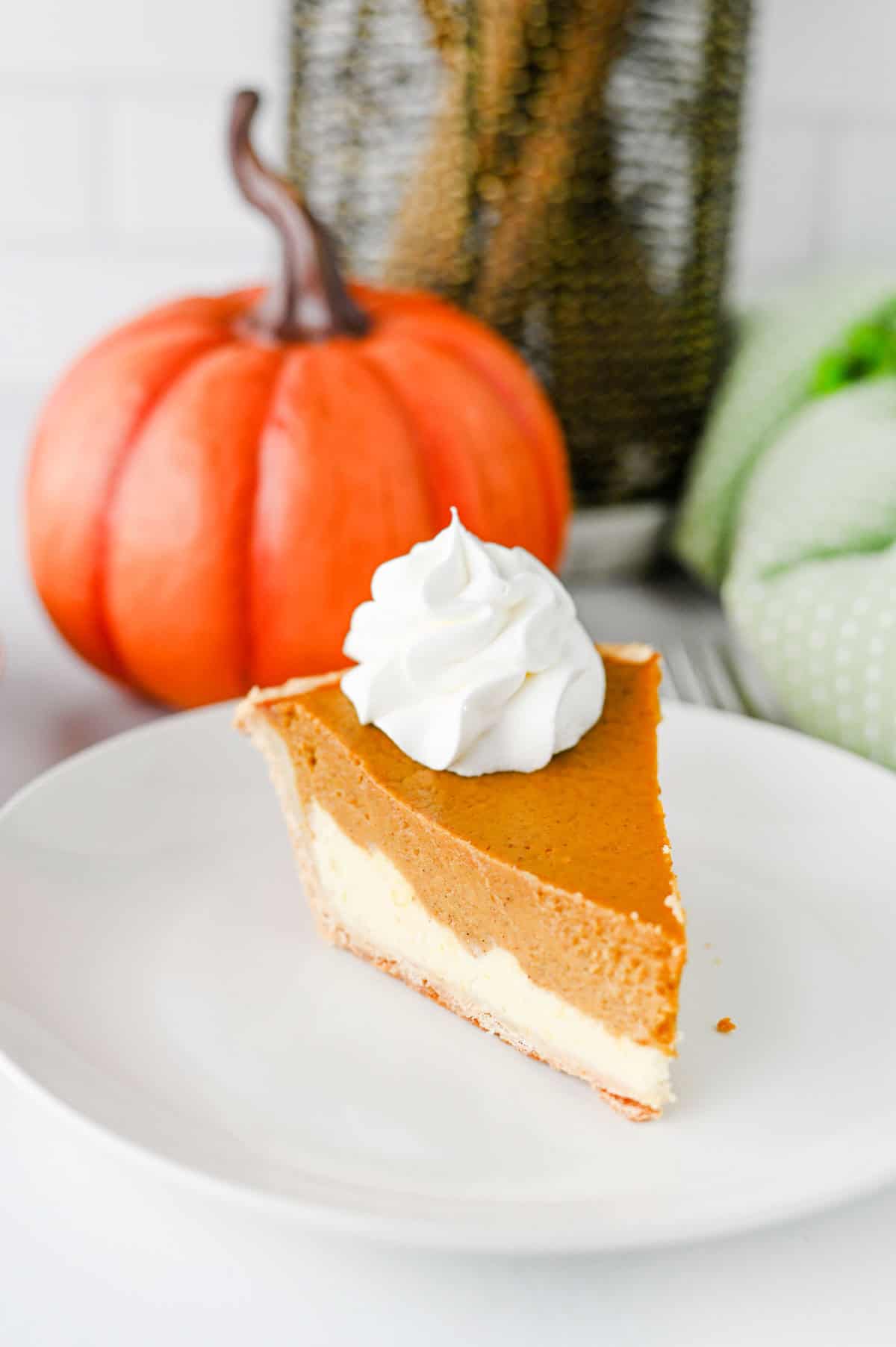 Pumpkin Pie Cheesecake is the perfect fall dessert when you can’t decide between classic pumpkin pie and creamy cheesecake! This easy Pumpkin Pie Cheesecake Recipe starts with a premade flaky pie crust and layers a sweet vanilla cream cheese filling with a rich pumpkin pie filling made with pumpkin puree, brown sugar, pumpkin pie spice, eggs, and heavy cream. It’s a delicious Thanksgiving dessert, holiday pie recipe, and fall baking idea for family dinners, potlucks, Friendsgiving, or Christmas. If you love easy pumpkin desserts, pumpkin cheesecake recipes, homemade pumpkin pie, and creamy cheesecake, this layered dessert is a must-try. Save this easy pumpkin cheesecake pie for your fall dessert recipes, Thanksgiving pie ideas, holiday baking, and pumpkin recipes to make all season long!