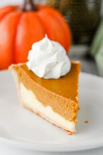 Pumpkin Pie Cheesecake is the perfect fall dessert when you can’t decide between classic pumpkin pie and creamy cheesecake! This easy Pumpkin Pie Cheesecake Recipe starts with a premade flaky pie crust and layers a sweet vanilla cream cheese filling with a rich pumpkin pie filling made with pumpkin puree, brown sugar, pumpkin pie spice, eggs, and heavy cream. It’s a delicious Thanksgiving dessert, holiday pie recipe, and fall baking idea for family dinners, potlucks, Friendsgiving, or Christmas. If you love easy pumpkin desserts, pumpkin cheesecake recipes, homemade pumpkin pie, and creamy cheesecake, this layered dessert is a must-try. Save this easy pumpkin cheesecake pie for your fall dessert recipes, Thanksgiving pie ideas, holiday baking, and pumpkin recipes to make all season long!