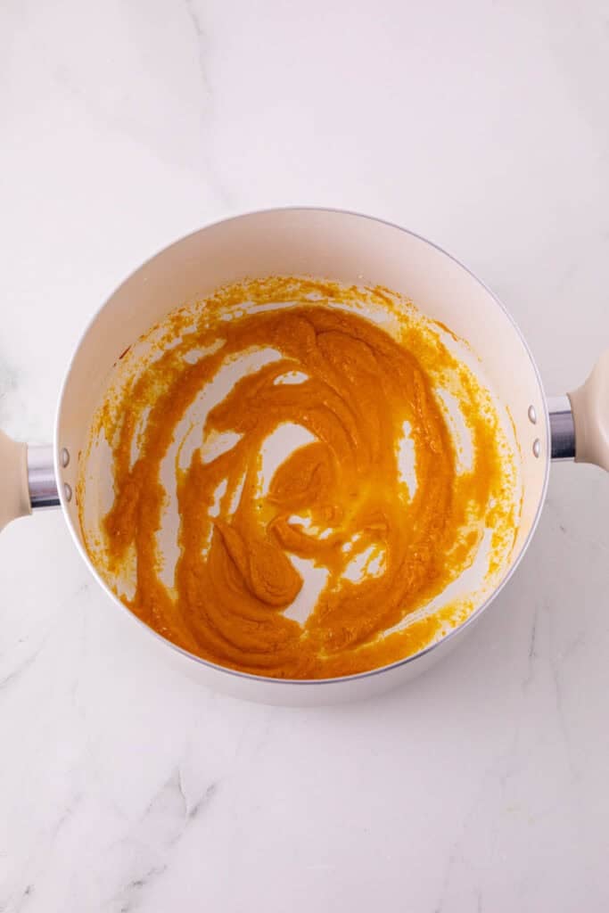 pumpkin puree added to pot with melted marshmallow mixture