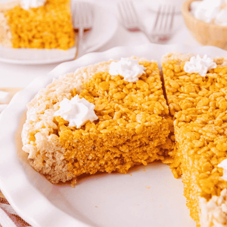 These Pumpkin Rice Krispie Treats are a fun fall dessert that turns classic marshmallow cereal treats into an adorable pumpkin pie! Made with buttery Rice Krispies, pumpkin puree, pumpkin pie spice and orange food coloring, this easy no bake dessert is perfect for Halloween parties, Thanksgiving dessert tables and fall gatherings. If you’re looking for easy pumpkin desserts, Halloween Rice Krispie treats, no bake fall desserts or easy fall treats for kids, this festive recipe is a must-try. The crispy Rice Krispie crust surrounds a soft, chewy pumpkin-spiced center that looks just like pumpkin pie. Add whipped topping before serving for a festive finish everyone will love. Save these Pumpkin Rice Krispie Treats for your fall baking, Halloween dessert and Thanksgiving treat ideas!
