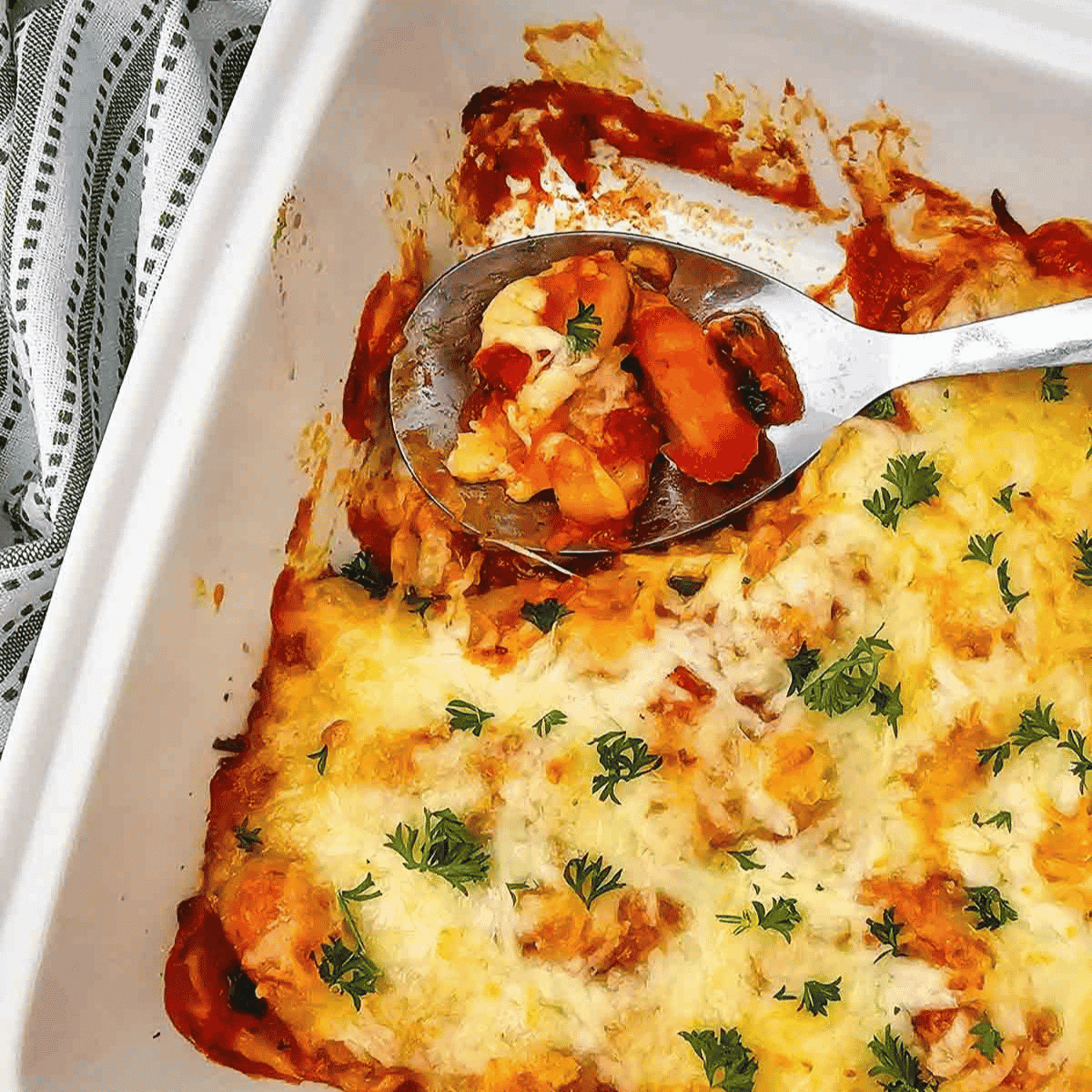 This easy Baked Gnocchi recipe is the perfect comfort food dinner for busy weeknights, lazy weekends, and family meals when you need something simple but satisfying. Tender potato gnocchi is layered with rich pasta sauce, shredded mozzarella cheese, parmesan cheese, and fresh parsley, then baked until hot, bubbly, and golden on top. This cheesy gnocchi bake is a quick casserole recipe made with just a few ingredients, but it tastes like a hearty Italian-inspired dinner everyone will love. Save this baked gnocchi casserole for an easy meatless dinner, simple pasta bake, vegetarian dinner idea, easy casserole recipe, cozy comfort food meal, kid-friendly dinner, quick weeknight recipe, or cheesy baked pasta dish served with garlic bread and salad.