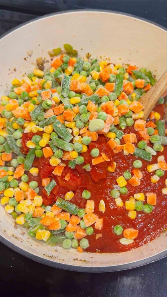 frozen mixed vegetables and tomato sauce in a large pot