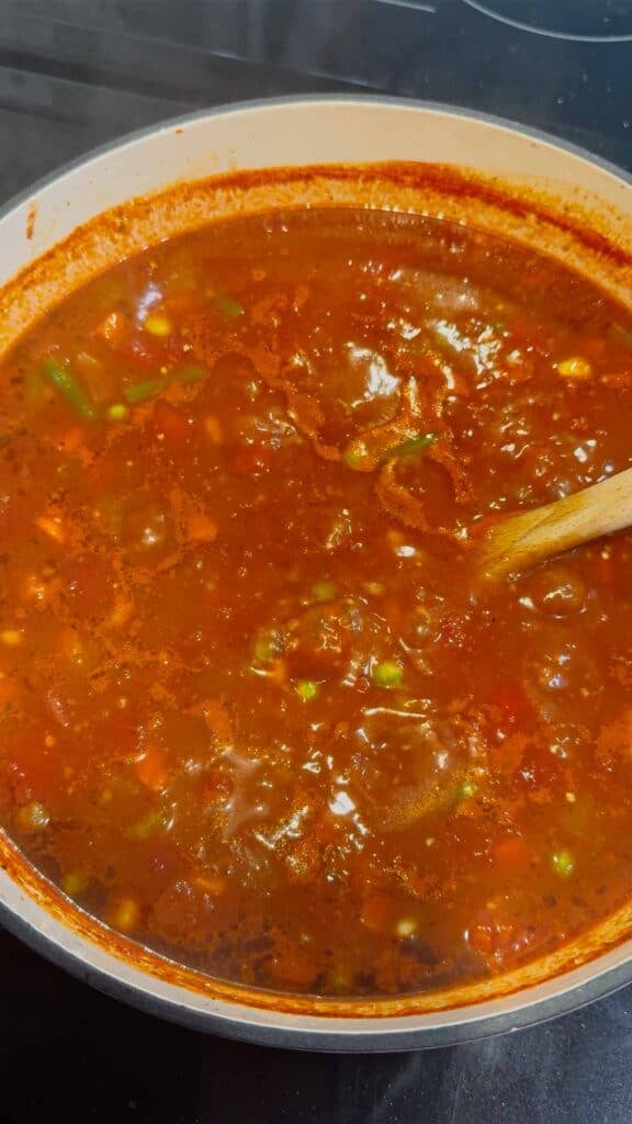 simmering beef vegetable soup in a pot