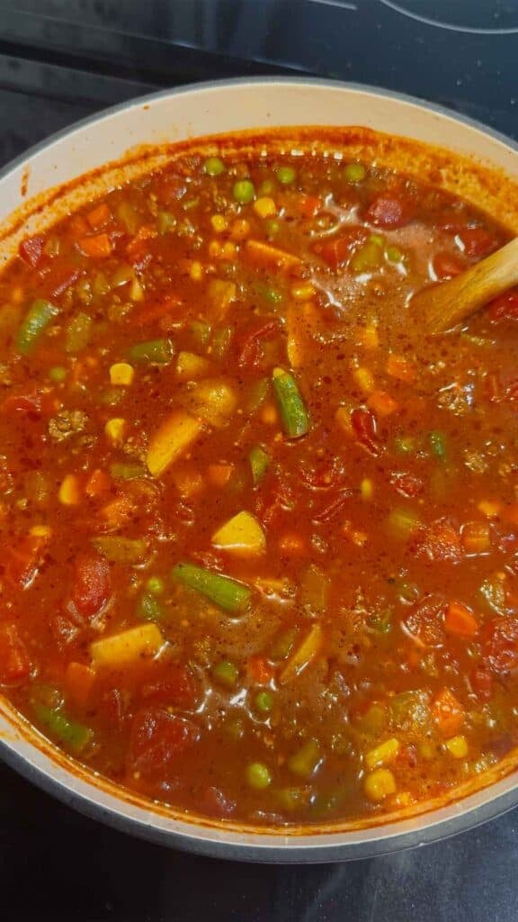 This Beef Vegetable Soup is an easy one-pot dinner loaded with seasoned ground beef, tender russet potatoes, diced tomatoes, celery, onions and colourful mixed vegetables in a rich tomato and beef broth. Ready in just 45 minutes, this hearty homemade soup is perfect for busy weeknights, chilly fall evenings and cozy winter dinners. Save this easy beef soup recipe when you need simple ground beef dinner ideas, comforting soup recipes, budget-friendly family meals or a quick way to use frozen vegetables. It’s a delicious vegetable beef soup for meal prep, freezer meals, cold-weather lunches and satisfying dinners the whole family will enjoy. Serve it with crusty bread, warm dinner rolls or crackers for an easy comfort food meal packed with meat, potatoes and vegetables.