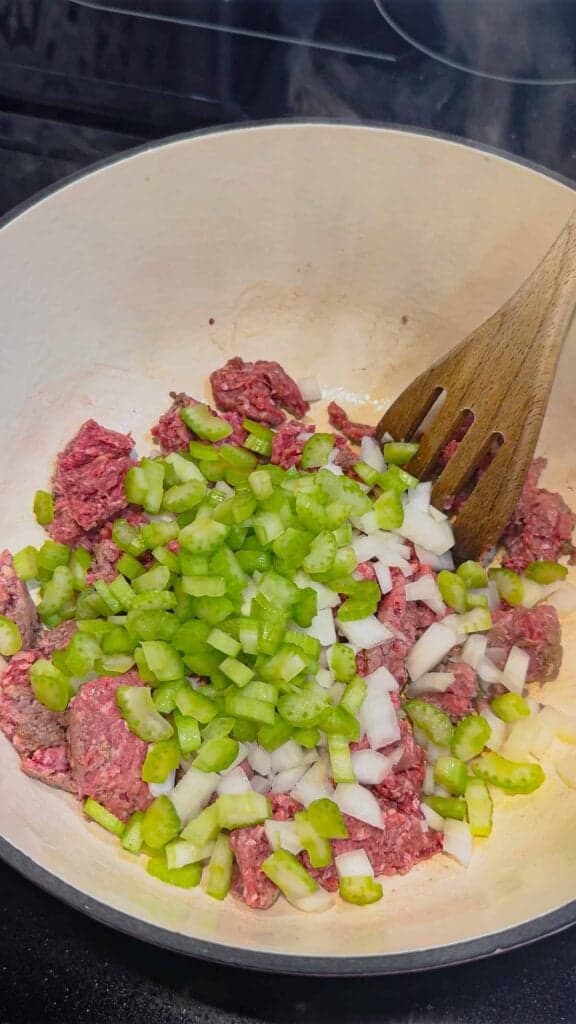 diced celery and onions added to pot with ground beef