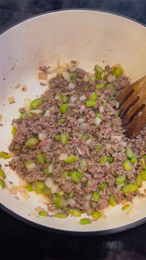 cooked ground beef, diced onions and celery in a large pot