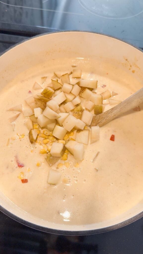 diced potatoes added to pot with creamy chicken soup