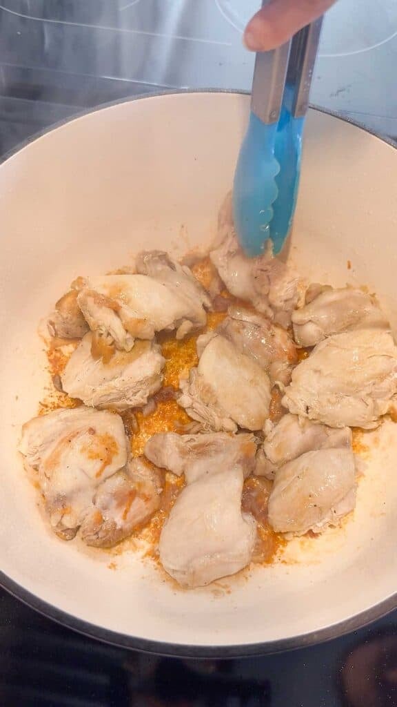 cooked chicken thighs in a large pot