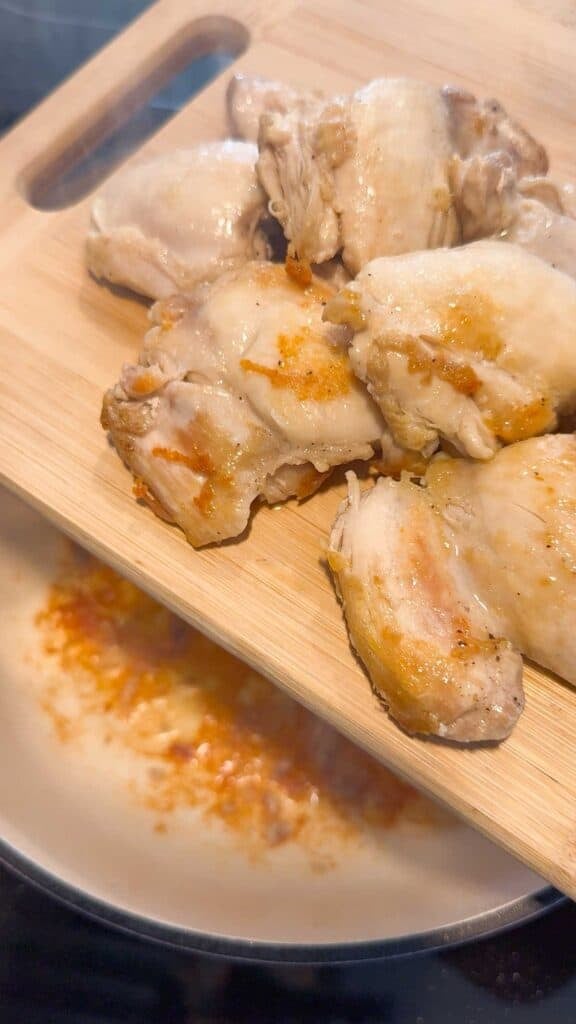 cooked chicken thighs on a cutting board