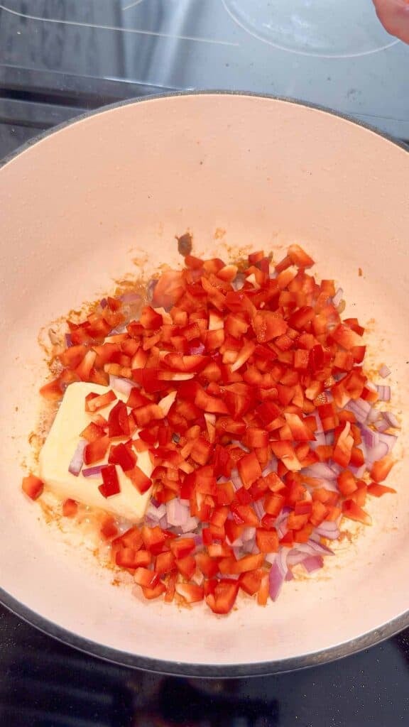 diced red bell peppers added to pot with butter
