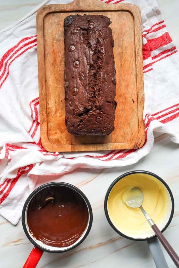 This Chocolate Loaf Cake is a rich, moist and decadent dessert that's perfect for chocolate lovers! This easy Chocolate Loaf Cake Recipe is made with cocoa powder, buttermilk and dark chocolate chips for a soft, tender crumb packed with chocolate flavor. Topped with a dark chocolate and white chocolate drizzle, this homemade chocolate bread makes an impressive but simple dessert for any occasion. If you're looking for Easy Loaf Cake Recipes, Chocolate Dessert Recipes, Chocolate Bread Recipes, Easy Baking Recipes or a Moist Chocolate Cake Recipe, this one belongs on your baking list. Serve this Chocolate Chip Loaf Cake for birthdays, holidays, afternoon treats, brunch or dessert. It's an easy chocolate cake that's delicious with coffee, tea or a glass of milk and perfect for sharing!