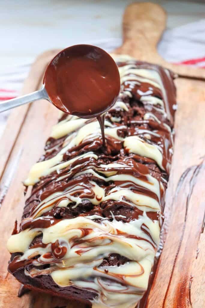 This Chocolate Loaf Cake is a rich, moist and decadent dessert that's perfect for chocolate lovers! This easy Chocolate Loaf Cake Recipe is made with cocoa powder, buttermilk and dark chocolate chips for a soft, tender crumb packed with chocolate flavor. Topped with a dark chocolate and white chocolate drizzle, this homemade chocolate bread makes an impressive but simple dessert for any occasion. If you're looking for Easy Loaf Cake Recipes, Chocolate Dessert Recipes, Chocolate Bread Recipes, Easy Baking Recipes or a Moist Chocolate Cake Recipe, this one belongs on your baking list. Serve this Chocolate Chip Loaf Cake for birthdays, holidays, afternoon treats, brunch or dessert. It's an easy chocolate cake that's delicious with coffee, tea or a glass of milk and perfect for sharing!